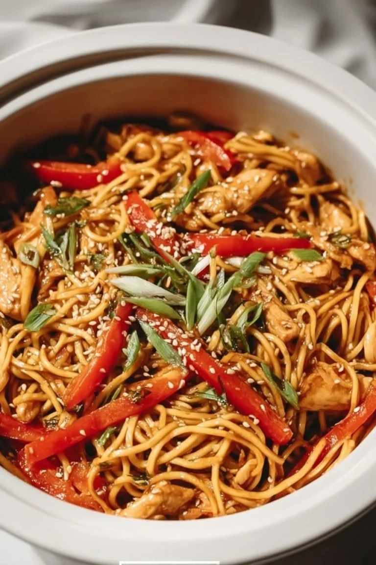Delicious slow cooker honey garlic chicken served over noodles.
