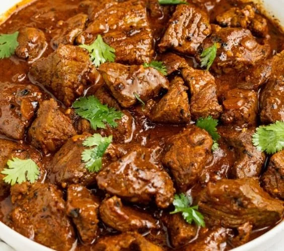 A delicious plate of Beef Vindaloo showcasing rich spices and garnished herbs
