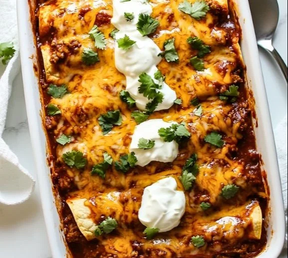 Delicious ground beef enchiladas topped with melted cheese and served hot.