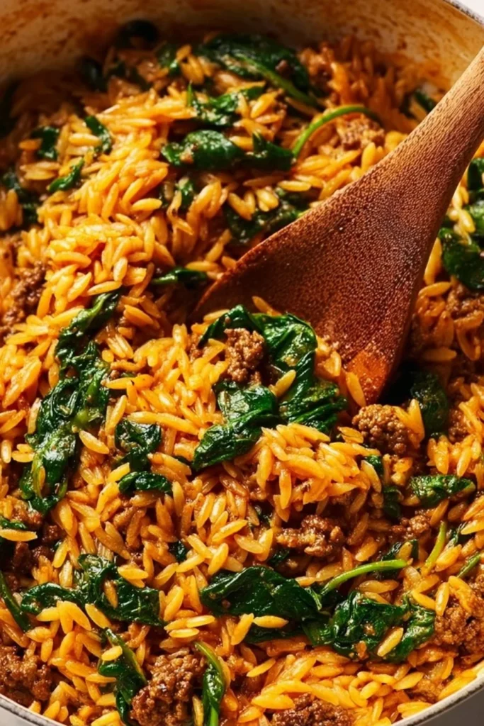 Creamy ground beef orzo skillet dish with fresh ingredients and spices